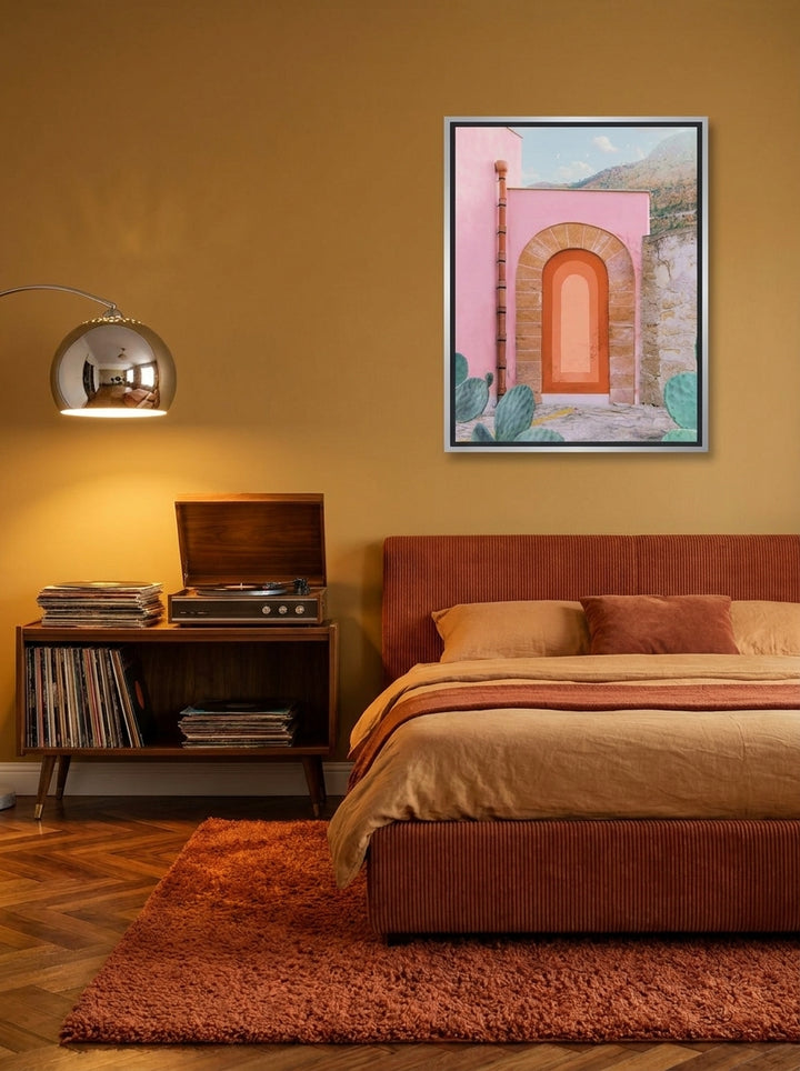 Canvas wall art with a silver leaf surround styled on the wall in a retro 70s bedroom