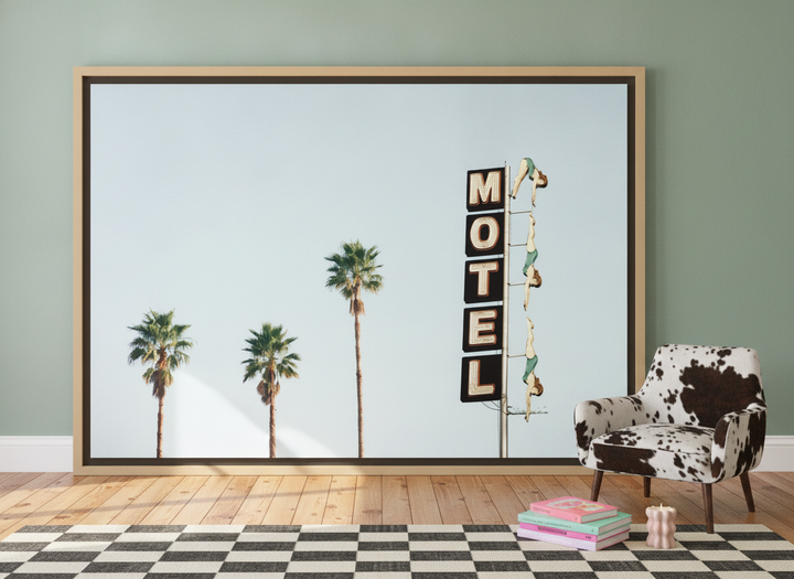 Oversized statement canvas wall art with a natural timber surround leaning against the wall in a colourful eclectic bedroom