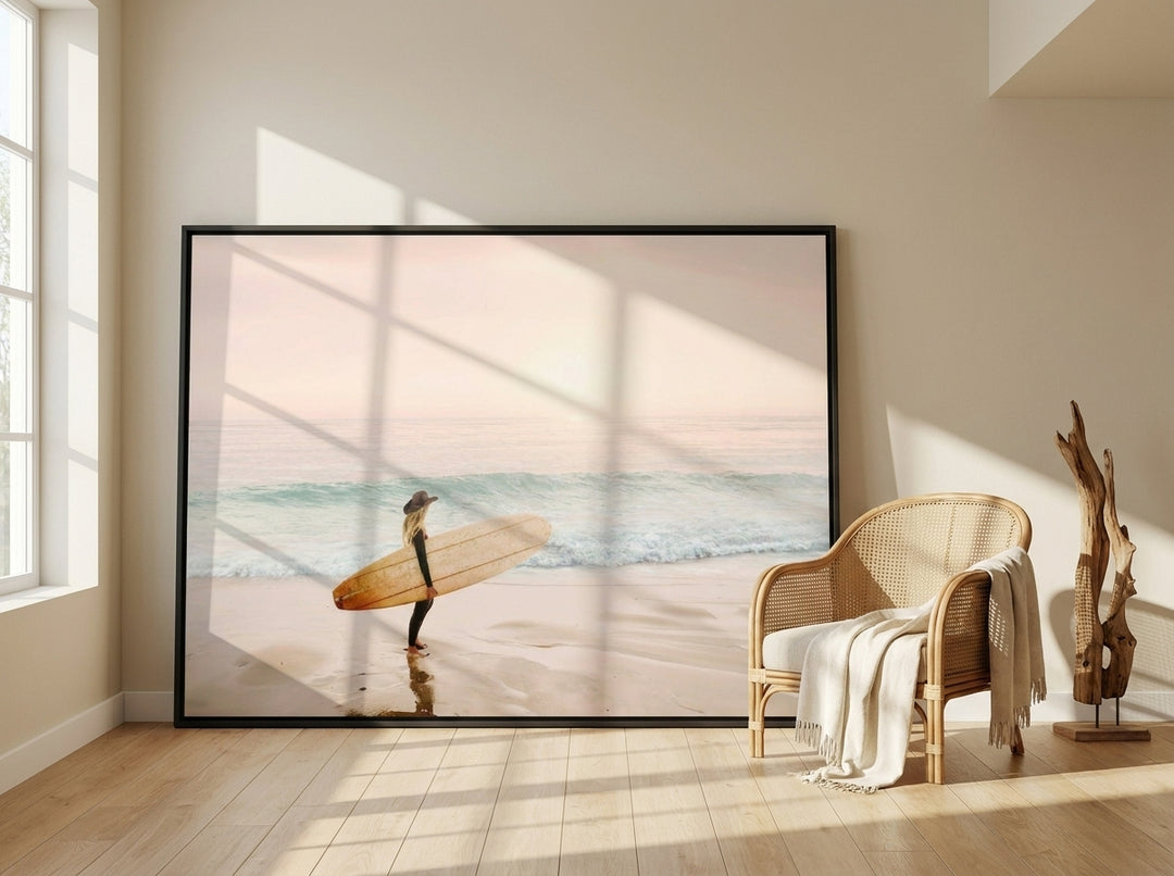 Oversized statement canvas wall art with a black surround leaning against the wall in a coastal bedroom