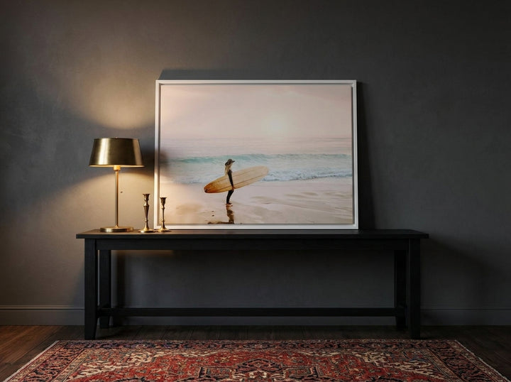 Canvas wall art with a white surround standing on a console in a moody living room