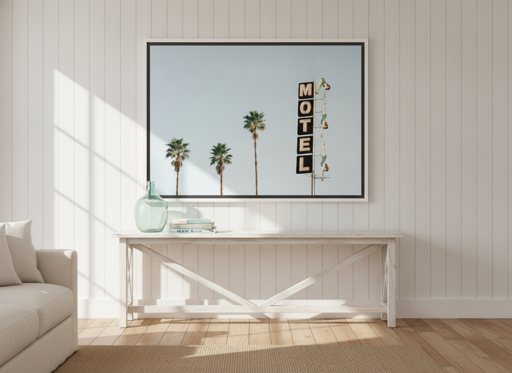 Oversized statement canvas wall art with a white surround styled on the wall in a coastal living room