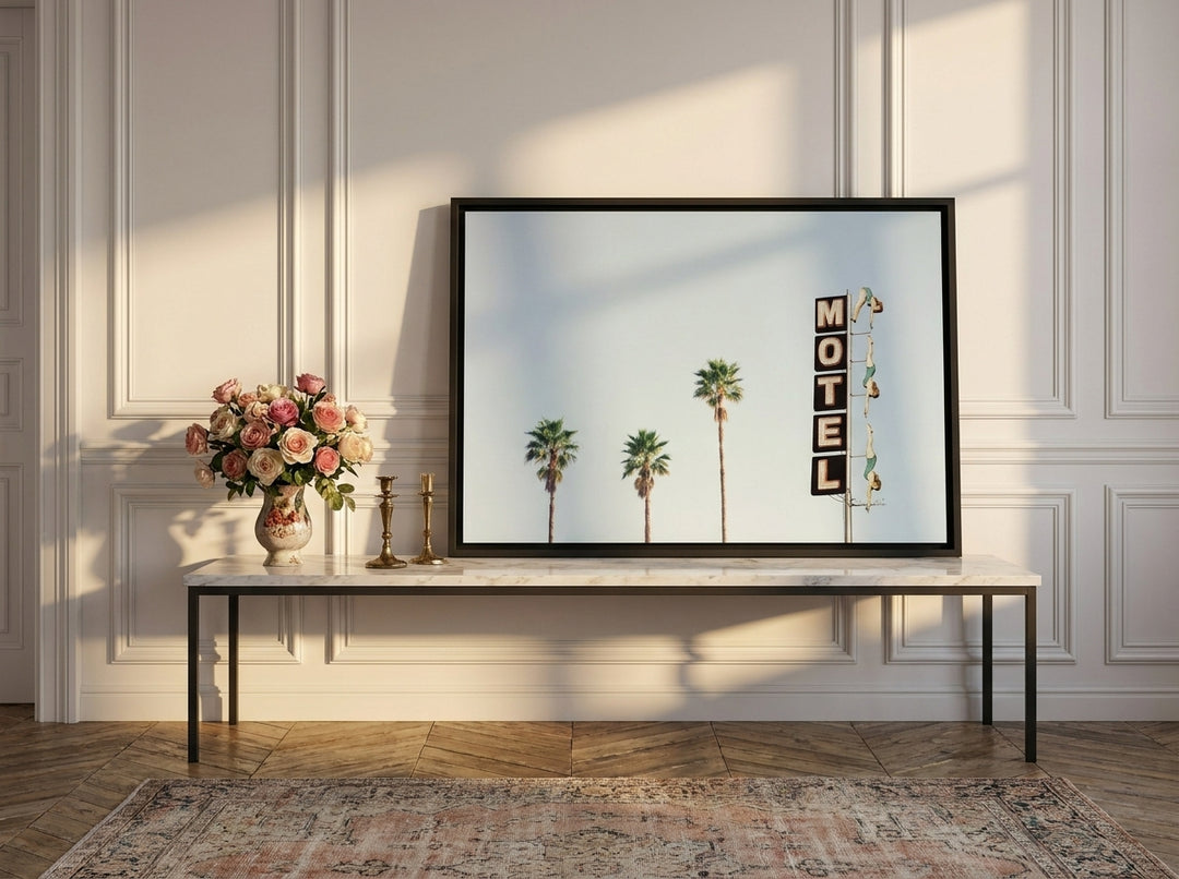 Canvas wall art with a black surround standing on a console in a Parisian bedroom
