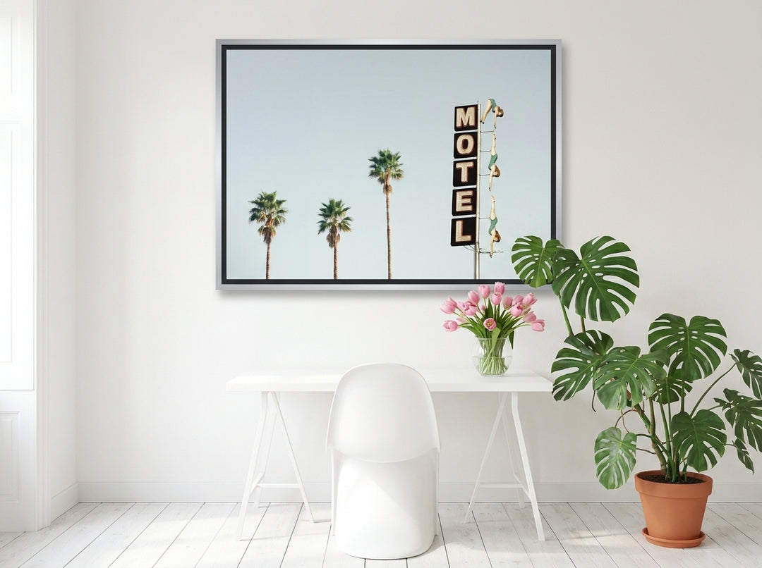 Canvas wall art with a silver leaf surround styled on the wall in a bright Scandinavian home office