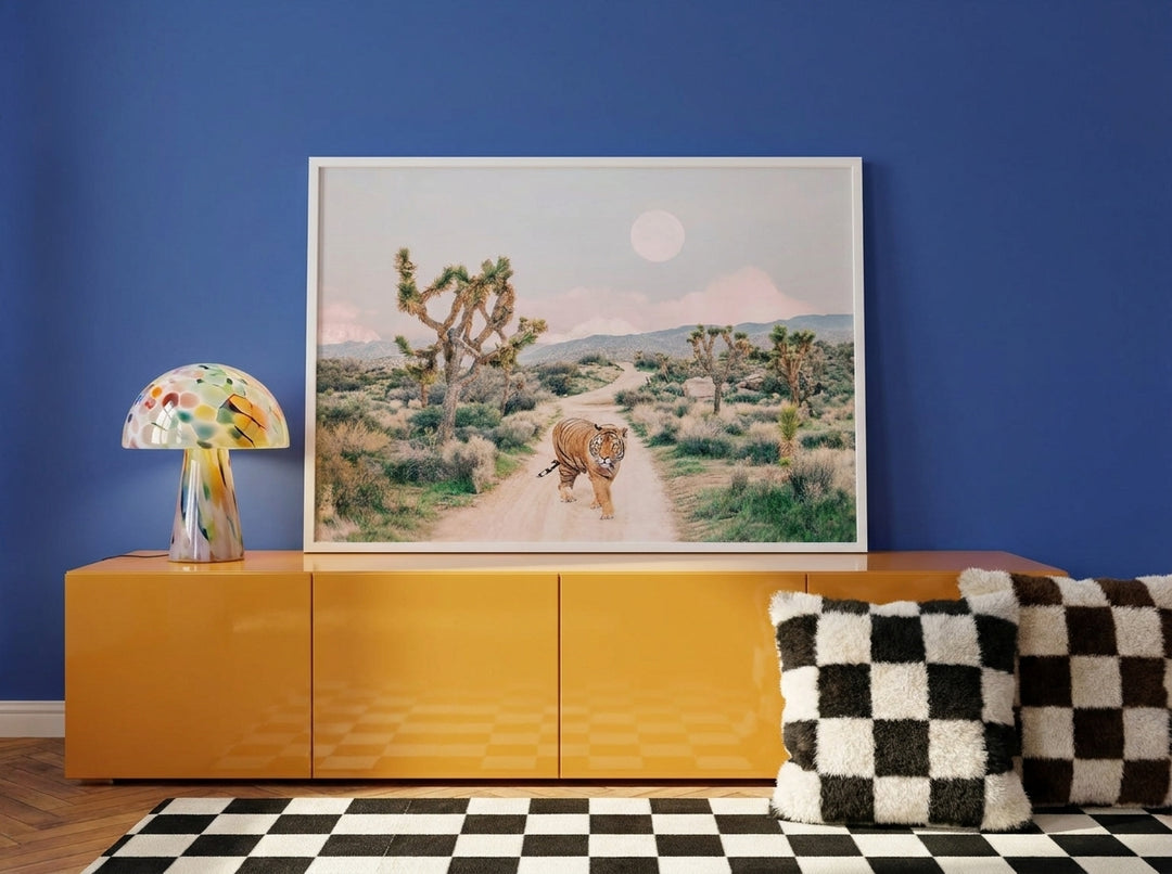 Modern wall art print standing on a sideboard in a colourful eclectic bedroom