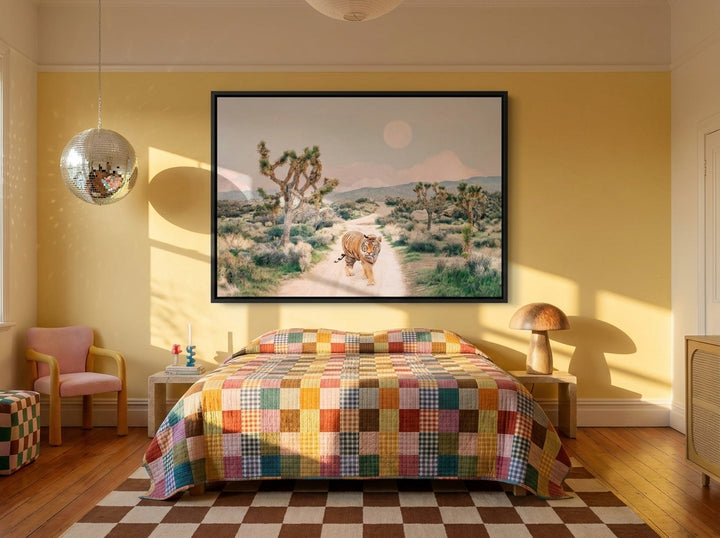 Oversized statement canvas wall art with a black surround styled on the wall in a colourful eclectic bedroom