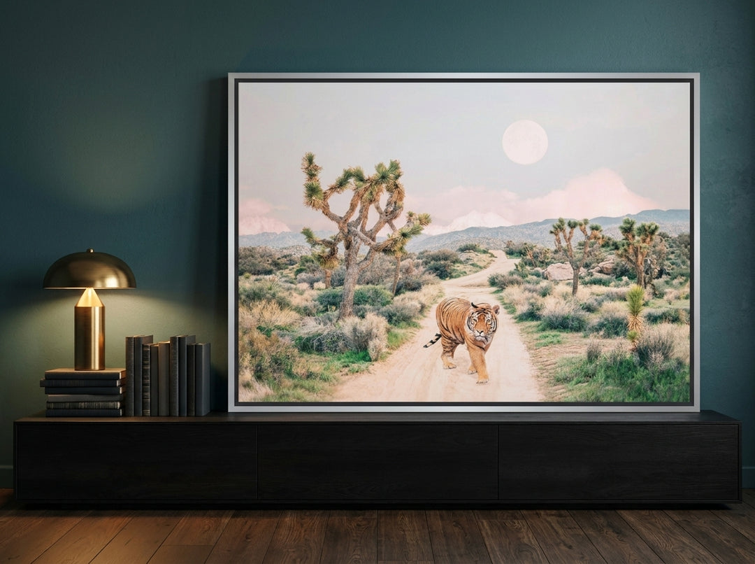 Canvas wall art with a silver leaf surround standing on a console in a moody home office