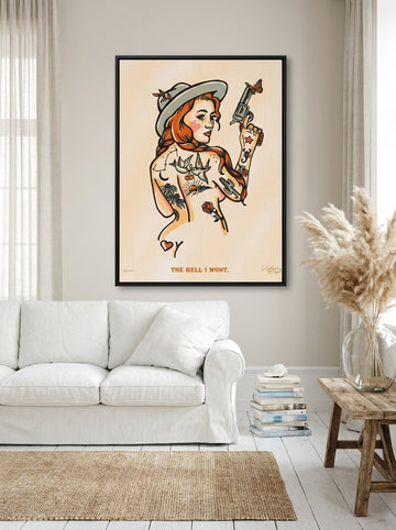 Oversized statement canvas wall art with a black surround styled on the wall in a coastal living room