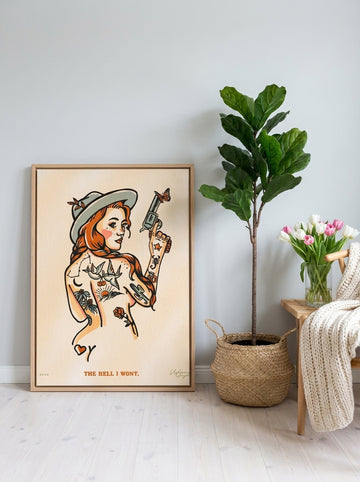 Canvas wall art with a natural timber surround leaning against the wall in a bright Scandinavian bedroom
