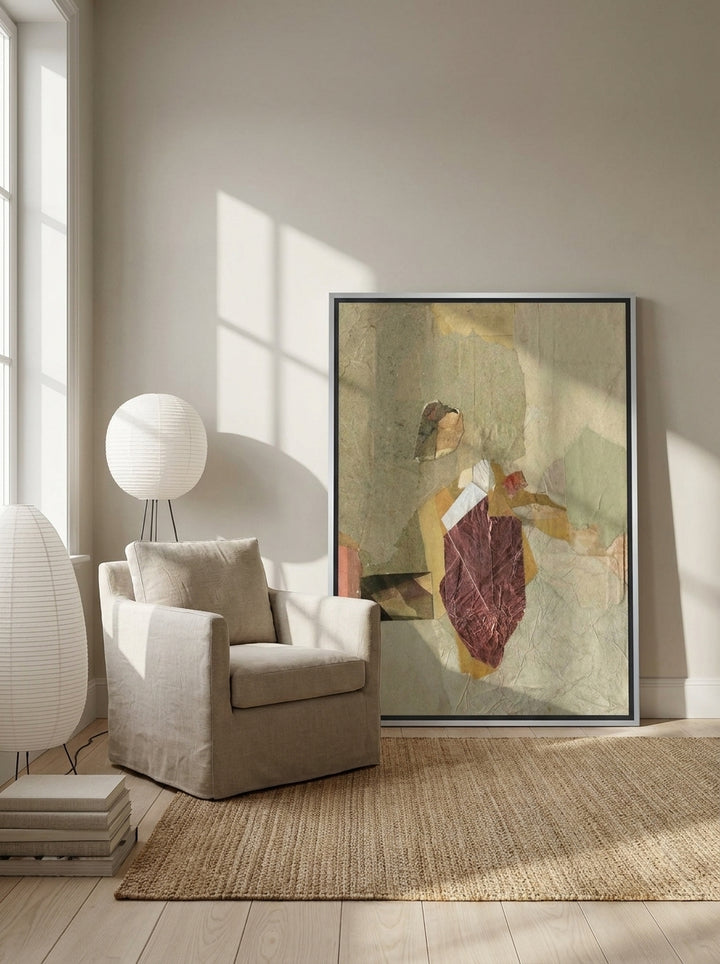 Canvas wall art with a silver leaf surround leaning against the wall in a warm Japandi bedroom