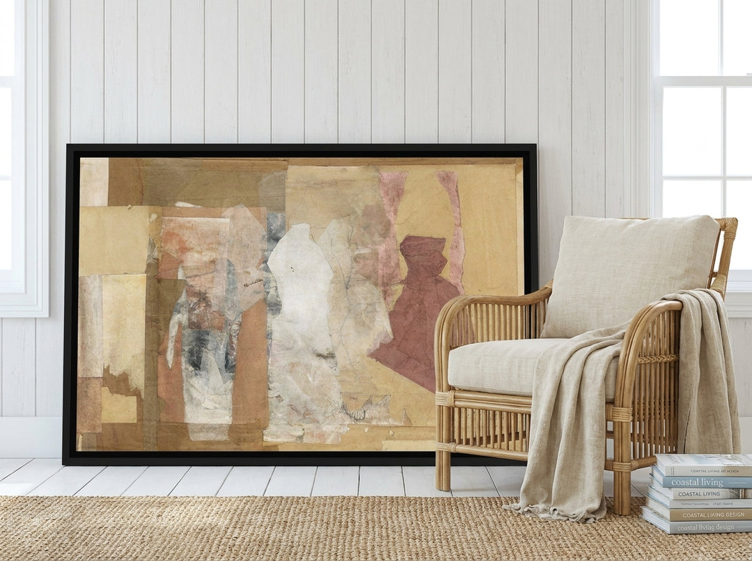 Canvas wall art with a black surround leaning against the wall in a coastal living room