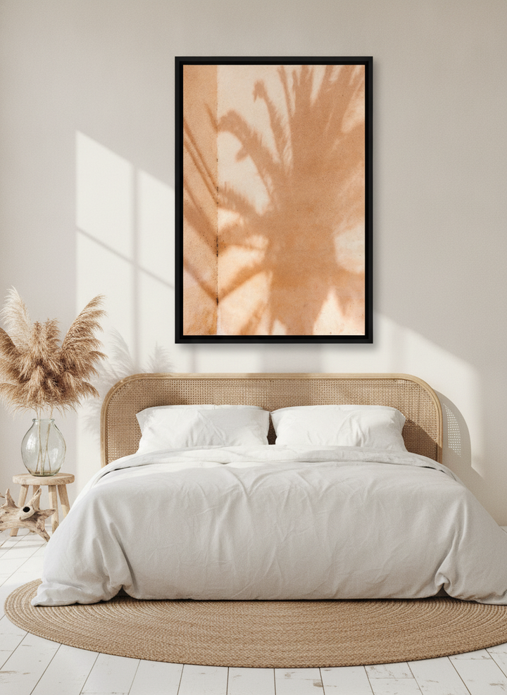 Oversized statement canvas wall art with a black surround styled on the wall in a coastal bedroom