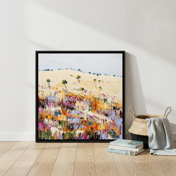Canvas wall art with a black surround leaning against the wall in a coastal bedroom
