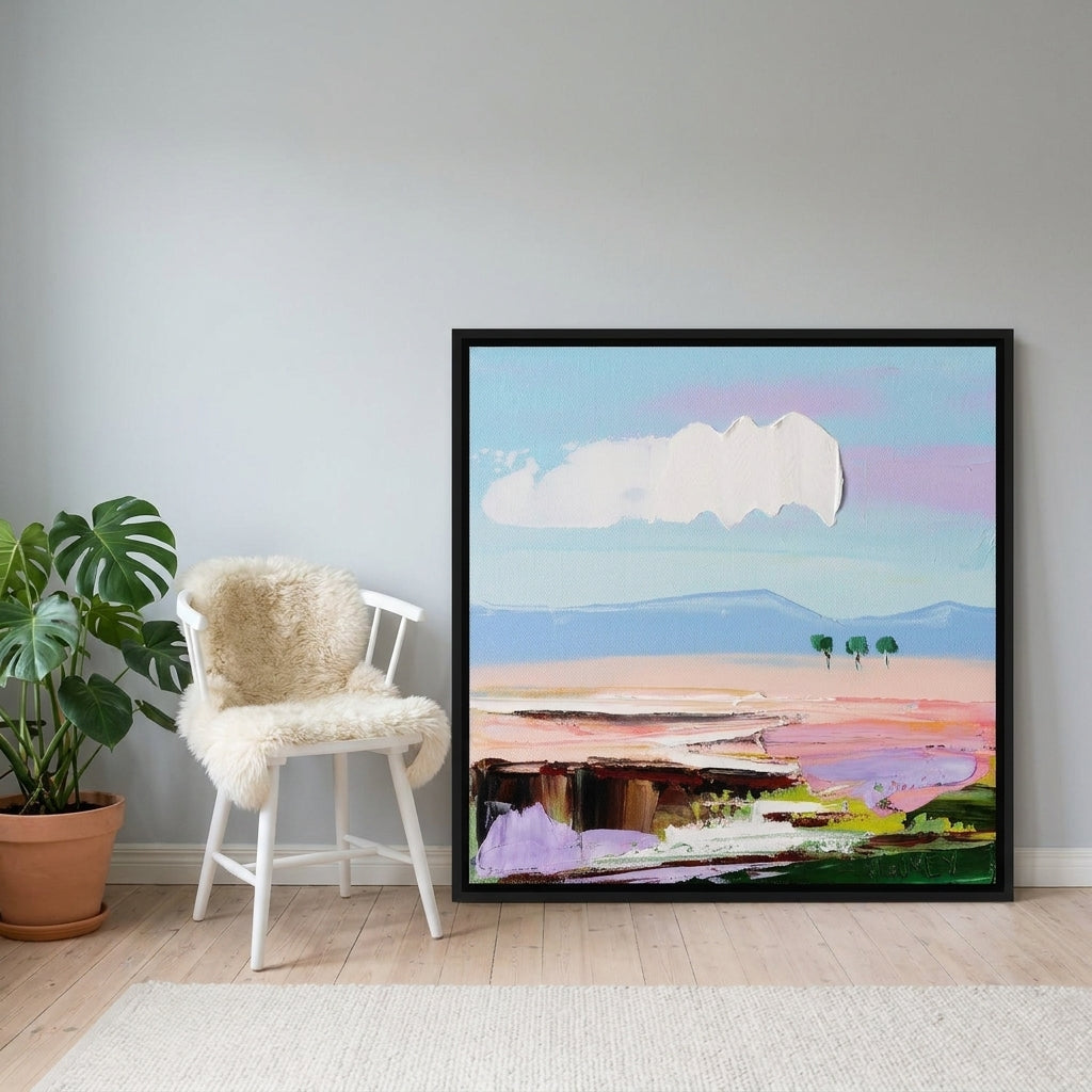 Canvas wall art with a black surround leaning against the wall in a bright Scandinavian home office