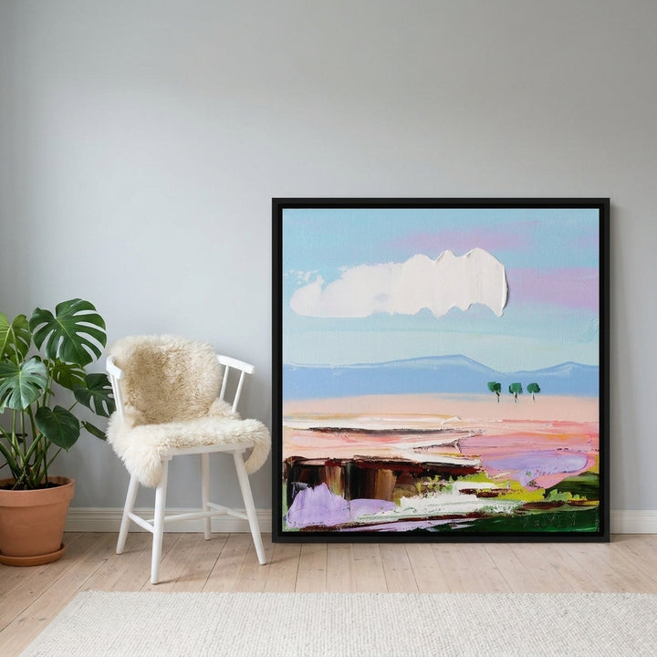 Canvas wall art with a black surround leaning against the wall in a bright Scandinavian home office