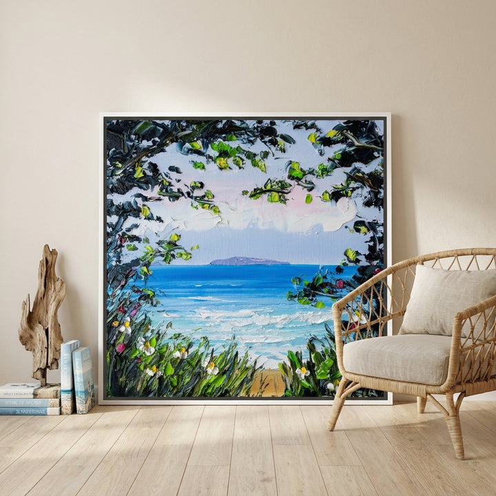 Canvas wall art with a white surround leaning against the wall in a coastal living room