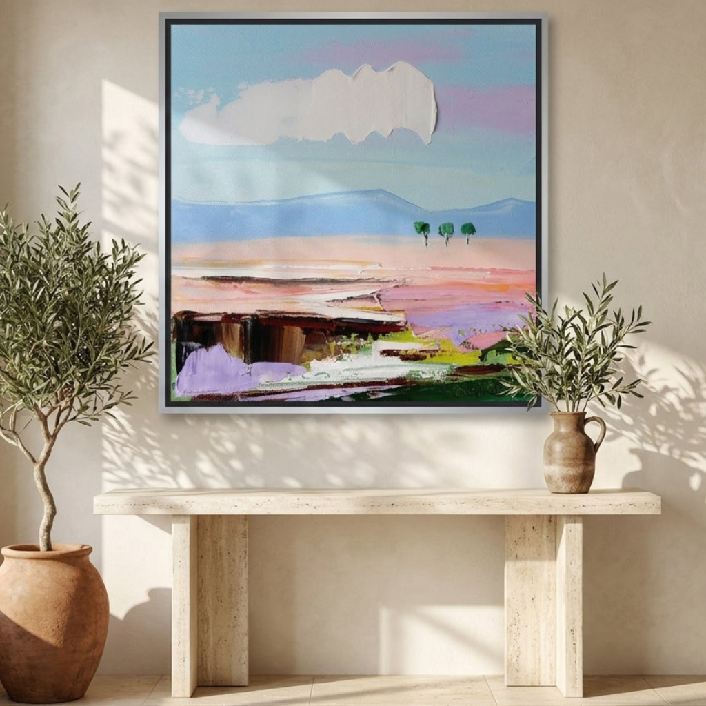 Oversized statement canvas wall art with a silver leaf surround styled on the wall in a Mediterranean living room