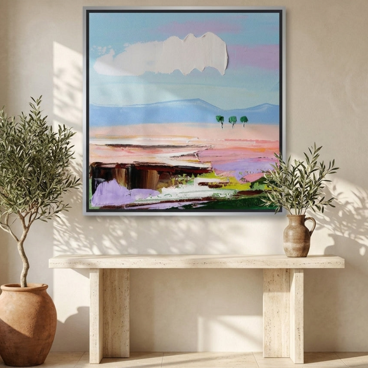 Oversized statement canvas wall art with a silver leaf surround styled on the wall in a Mediterranean living room