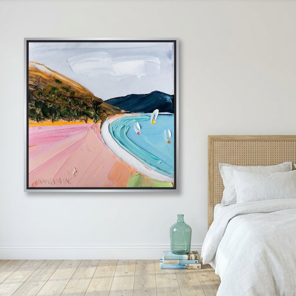 Canvas wall art with a silver leaf surround styled on the wall in a coastal bedroom