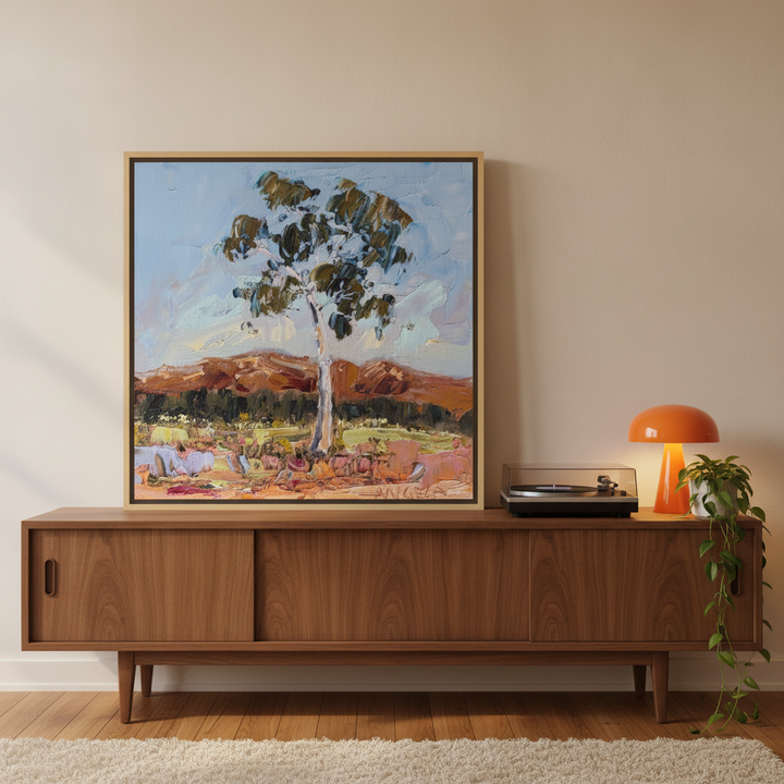 Canvas wall art with a natural timber surround standing on a sideboard in a retro 70s home office
