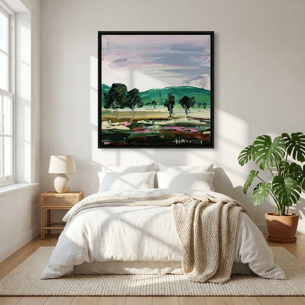 Canvas wall art with a black surround styled on the wall in a bright Scandinavian bedroom