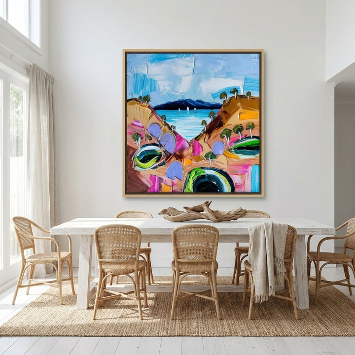 Oversized statement canvas wall art with a natural timber surround styled on the wall in a coastal dining room
