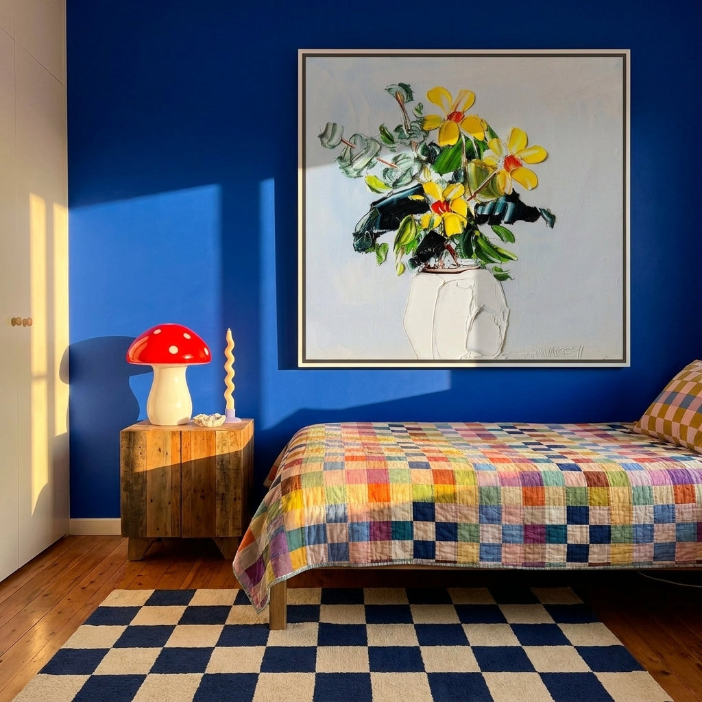 Oversized statement canvas wall art with a white surround styled on the wall in a colourful eclectic bedroom