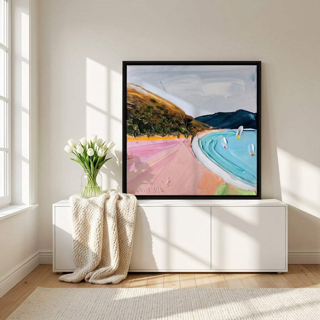 Canvas wall art with a black surround standing on a sideboard in a bright Scandinavian bedroom