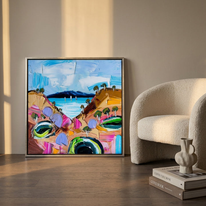 Canvas wall art with a silver leaf surround leaning against the wall in a luxe living room