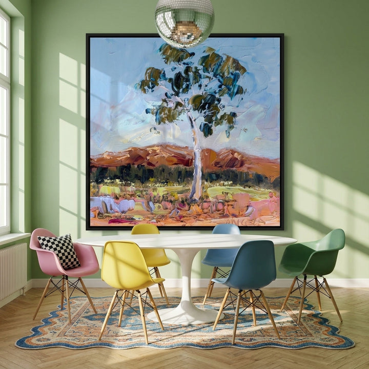 Oversized statement canvas wall art with a black surround styled on the wall in a colourful eclectic dining room