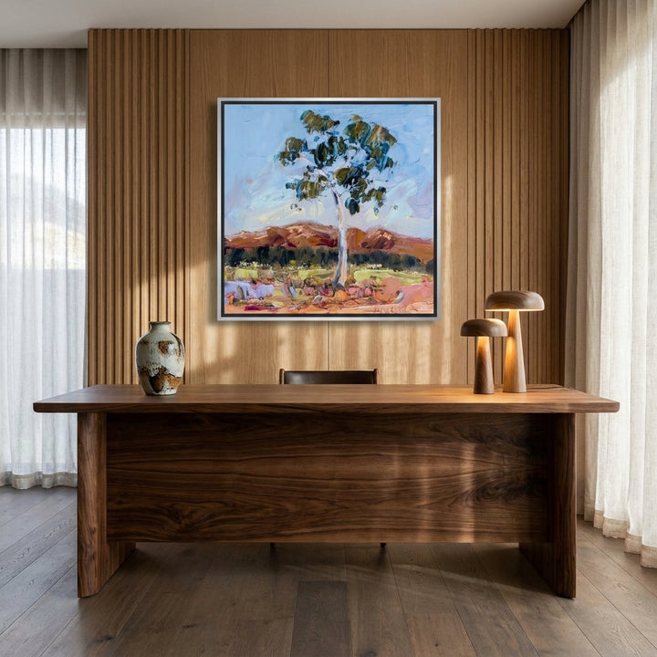 Canvas wall art with a silver leaf surround styled on the wall in a luxe home office