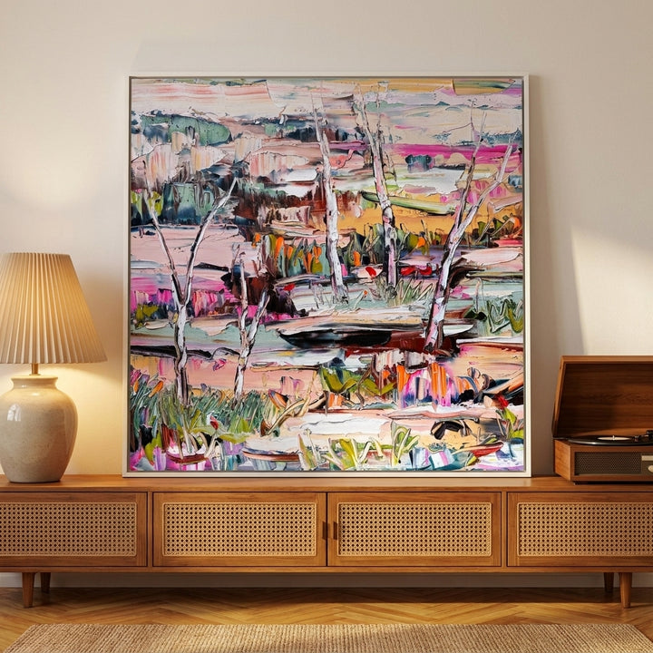 Canvas wall art with a white surround standing on a sideboard in a mid-century home office