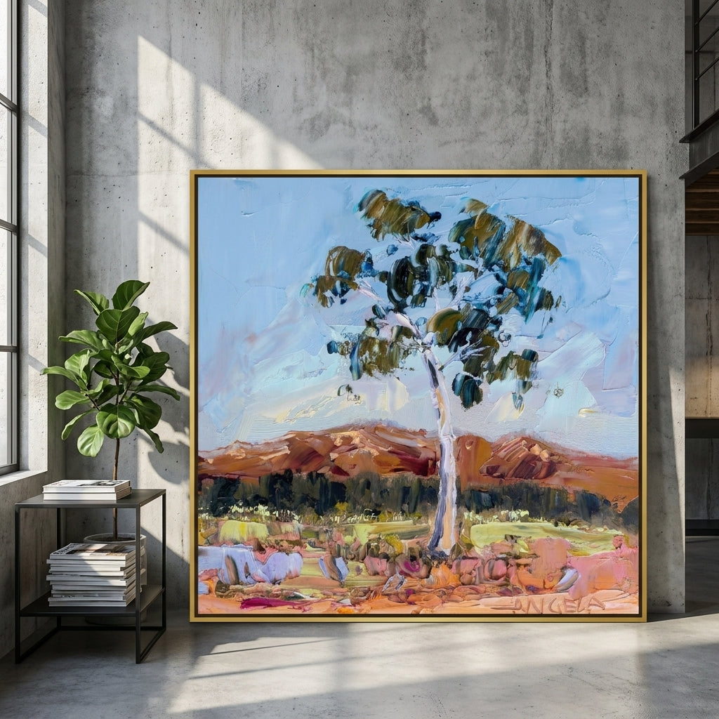 Oversized statement canvas wall art with a gold leaf surround leaning against the wall in an industrial loft living room