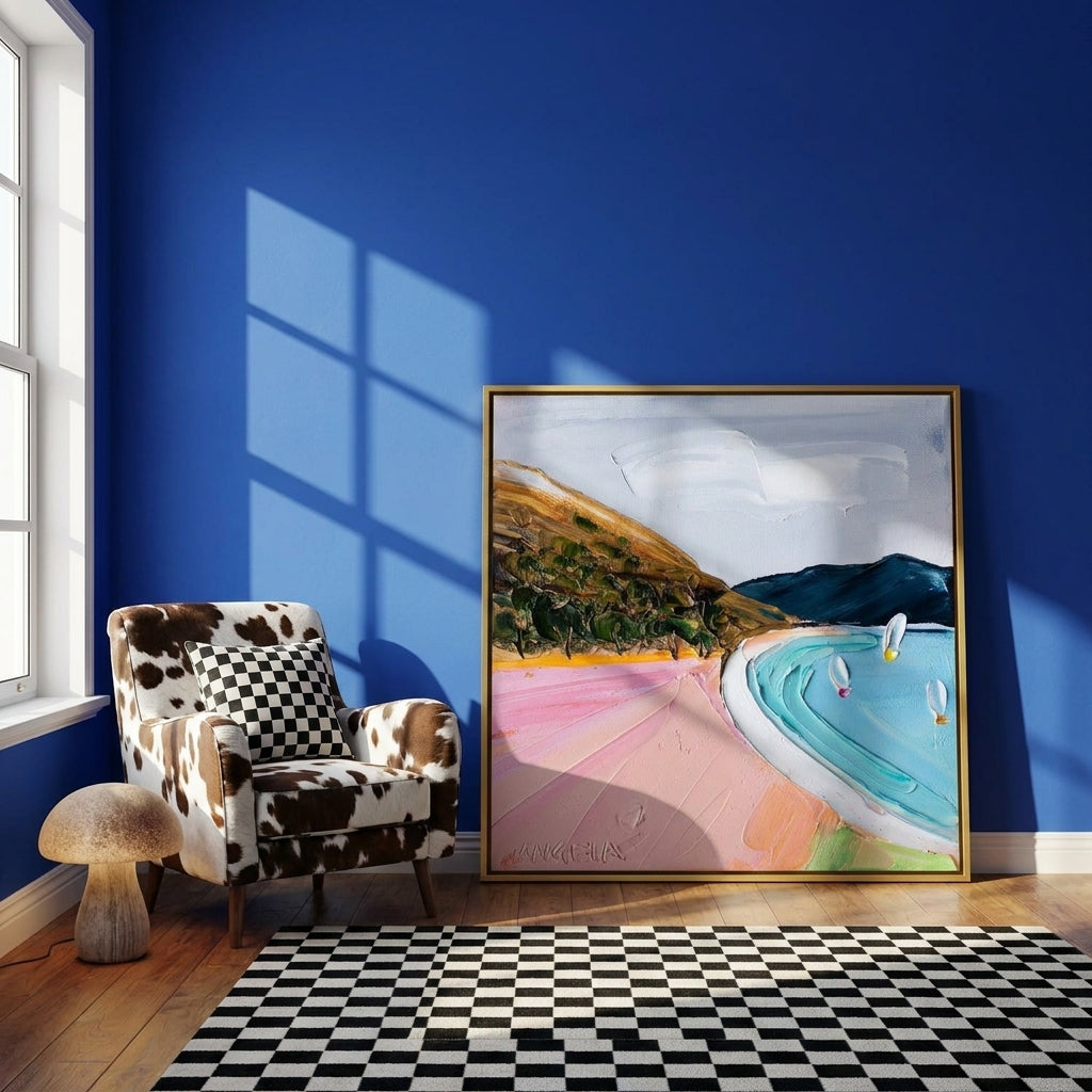 Canvas wall art with a gold leaf surround leaning against the wall in a colourful eclectic home office