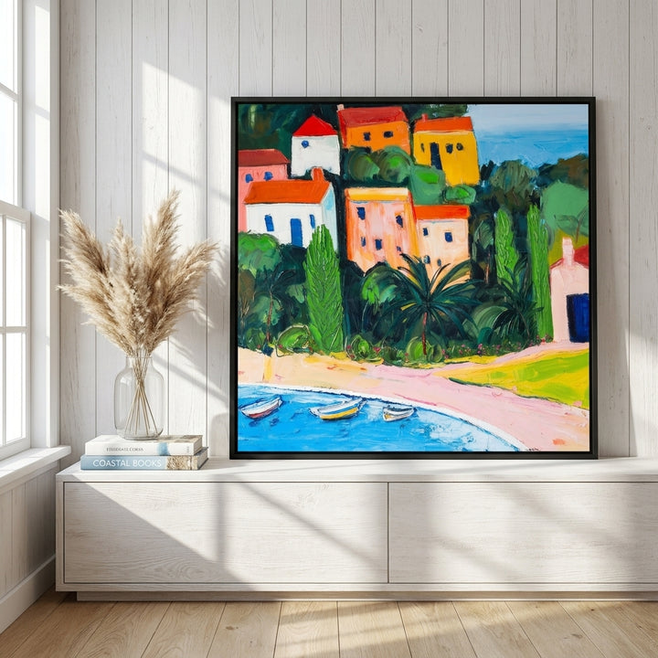 Canvas wall art with a black surround standing on a console in a coastal bedroom