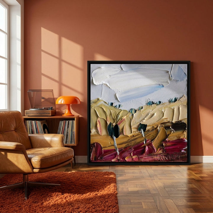 Canvas wall art with a black surround leaning against the wall in a retro 70s home office