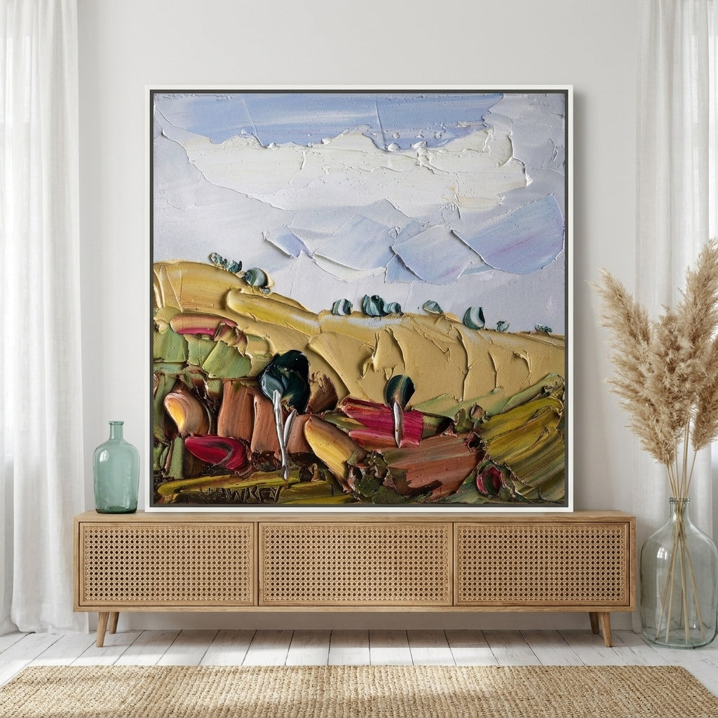 Canvas wall art with a white surround standing on a sideboard in a coastal home office