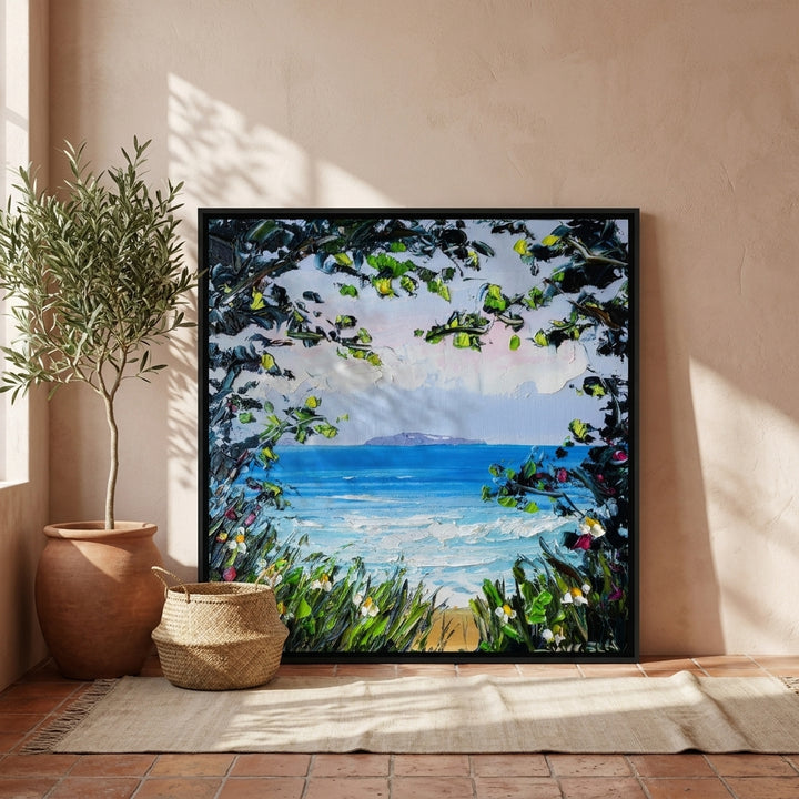 Oversized statement canvas wall art with a black surround leaning against the wall in a Mediterranean dining room