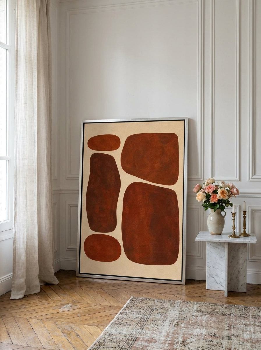 Canvas wall art with a silver leaf surround leaning against the wall in a Parisian bedroom