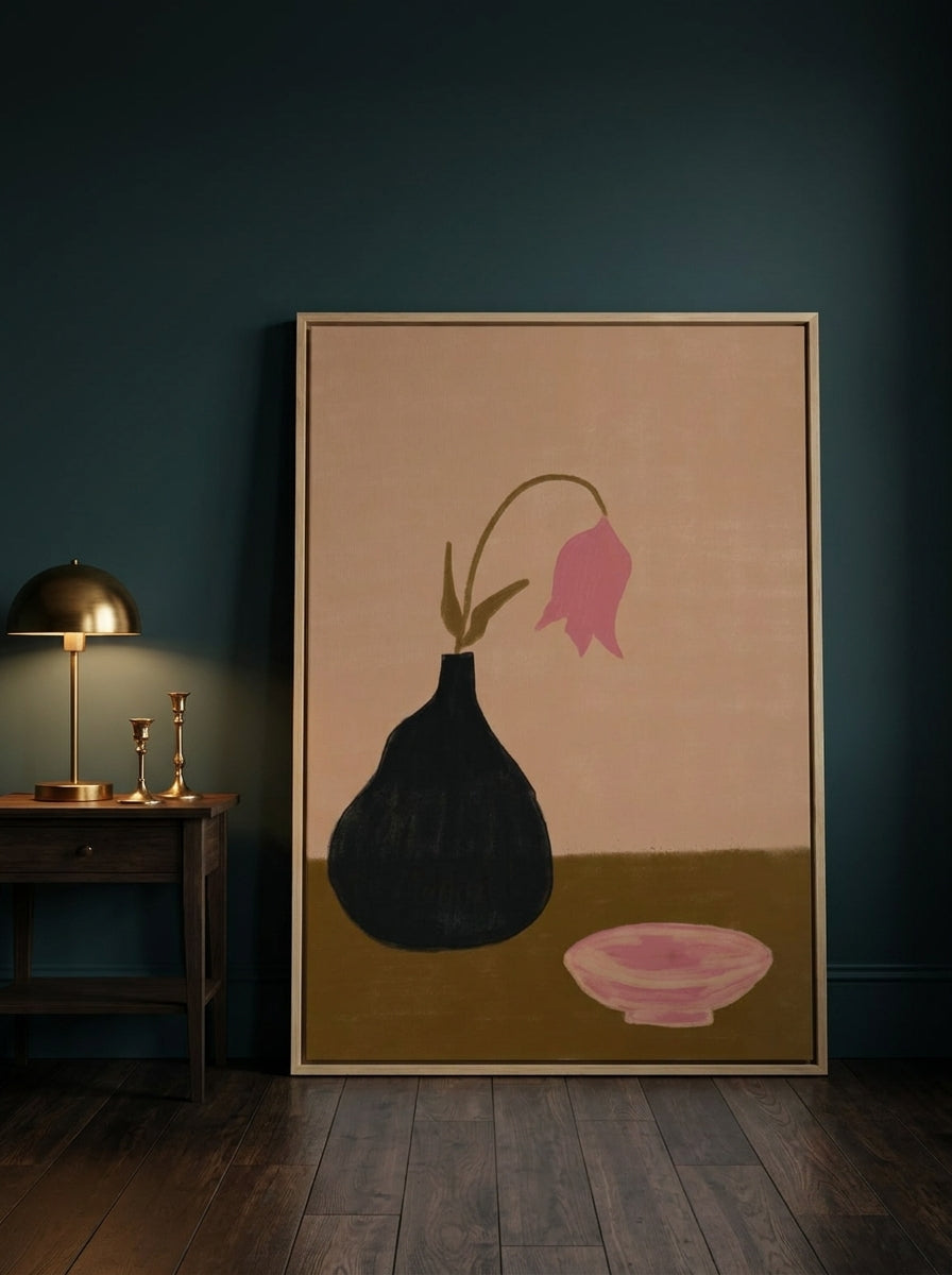 Oversized statement canvas wall art with a natural timber surround leaning against the wall in a moody bedroom