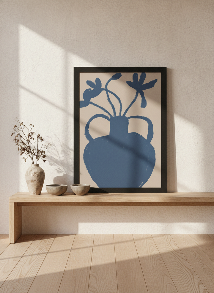 Modern wall art print standing on a bench in a warm Japandi bedroom