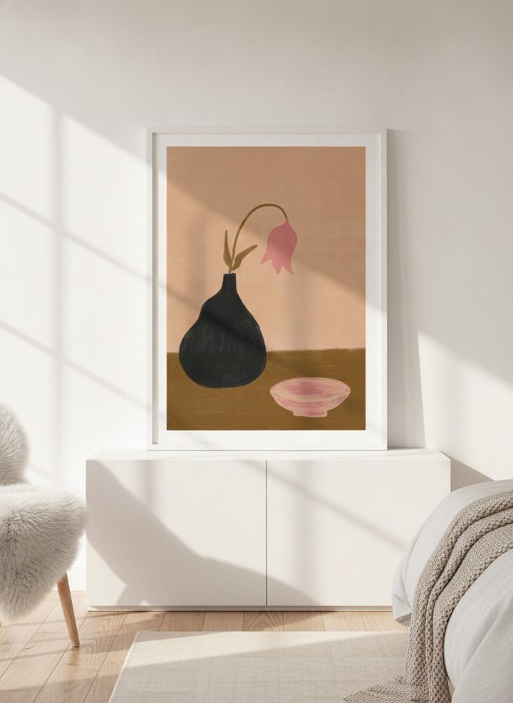Modern wall art print standing on a sideboard in a bright Scandinavian bedroom
