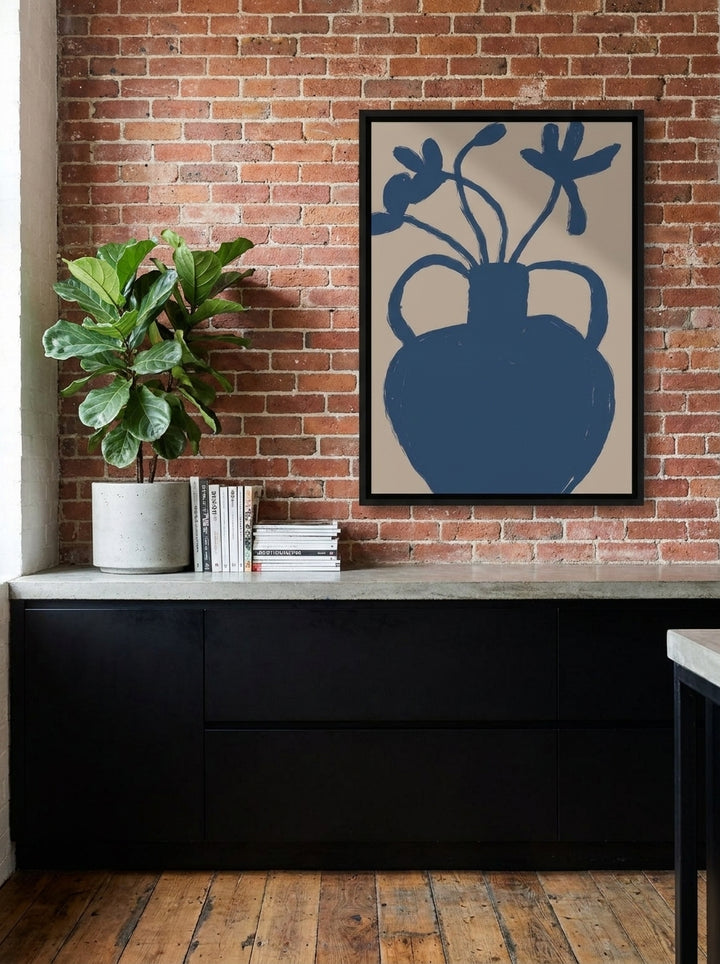 Canvas wall art with a black surround styled on the wall in an industrial loft kitchen