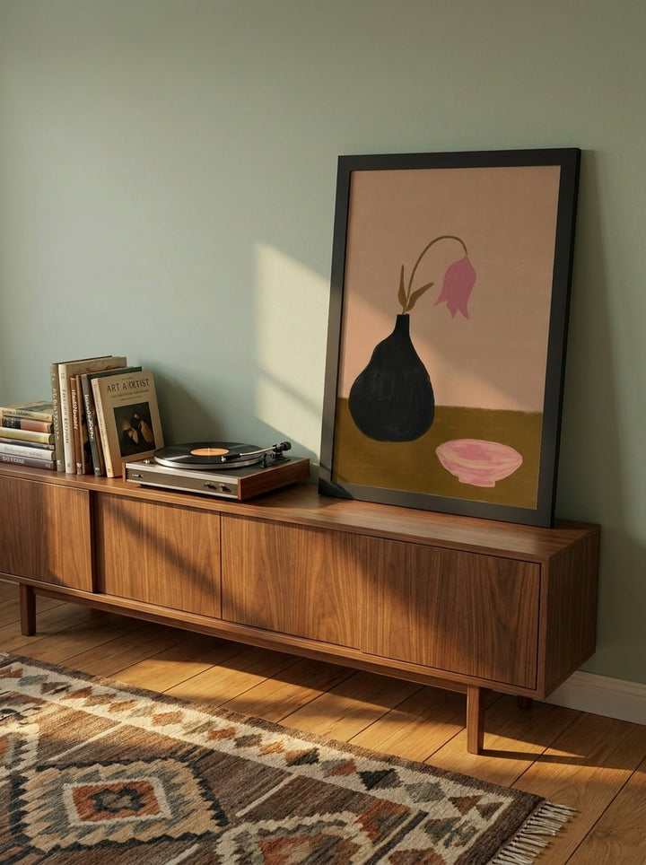 Modern wall art print standing on a sideboard in a mid-century home office