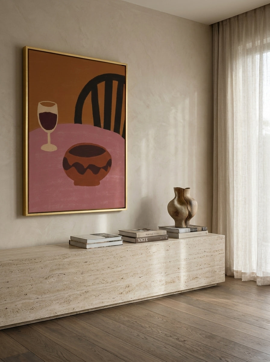 Oversized statement canvas wall art with a gold leaf surround styled on the wall in a luxe living room