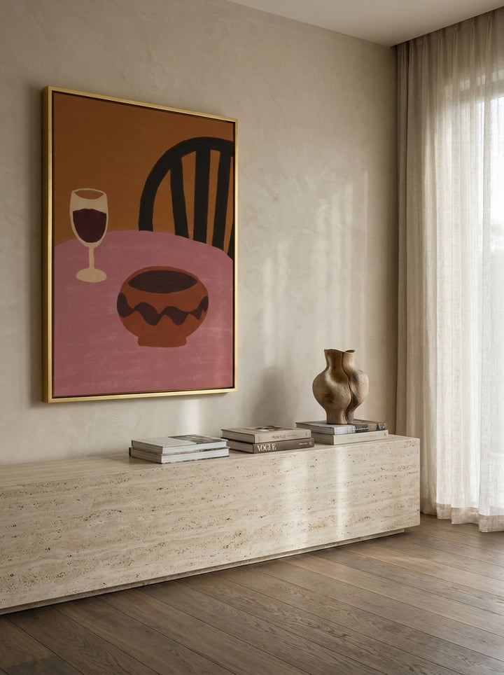 Oversized statement canvas wall art with a gold leaf surround styled on the wall in a luxe living room
