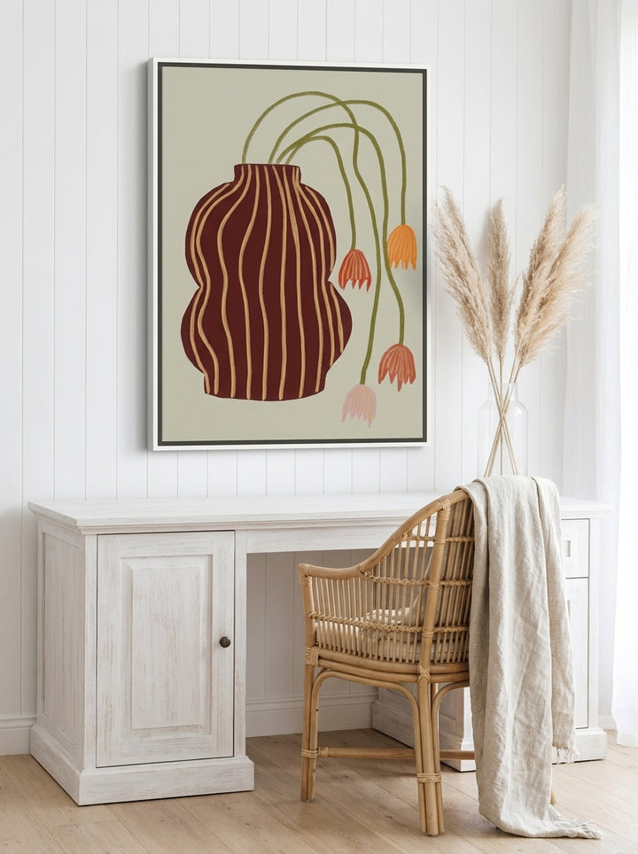 Canvas wall art with a white surround styled on the wall in a coastal home office