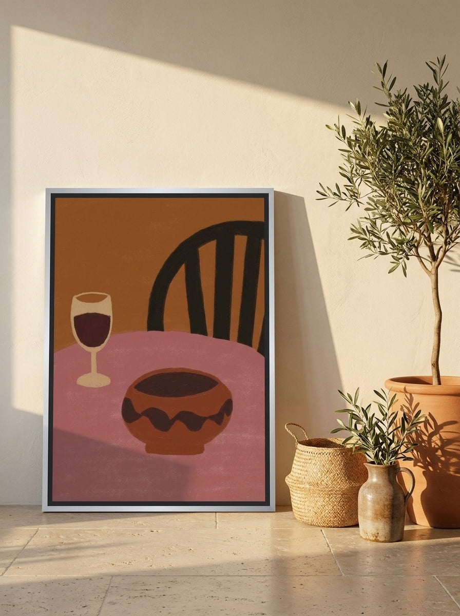 Canvas wall art with a silver leaf surround leaning against the wall in a Mediterranean home office