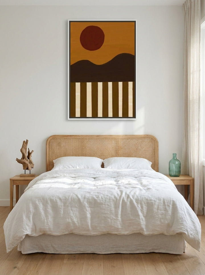 Canvas wall art with a white surround styled on the wall in a coastal bedroom