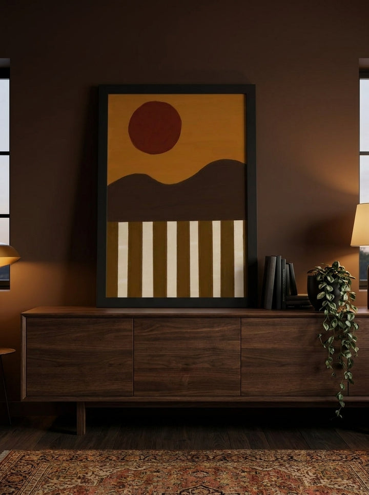 Modern wall art print standing on a sideboard in a moody living room