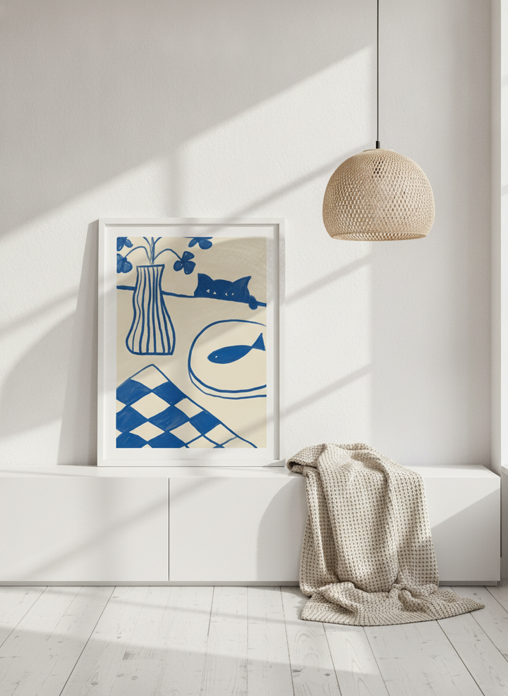 Modern wall art print standing on a sideboard in a bright Scandinavian living room